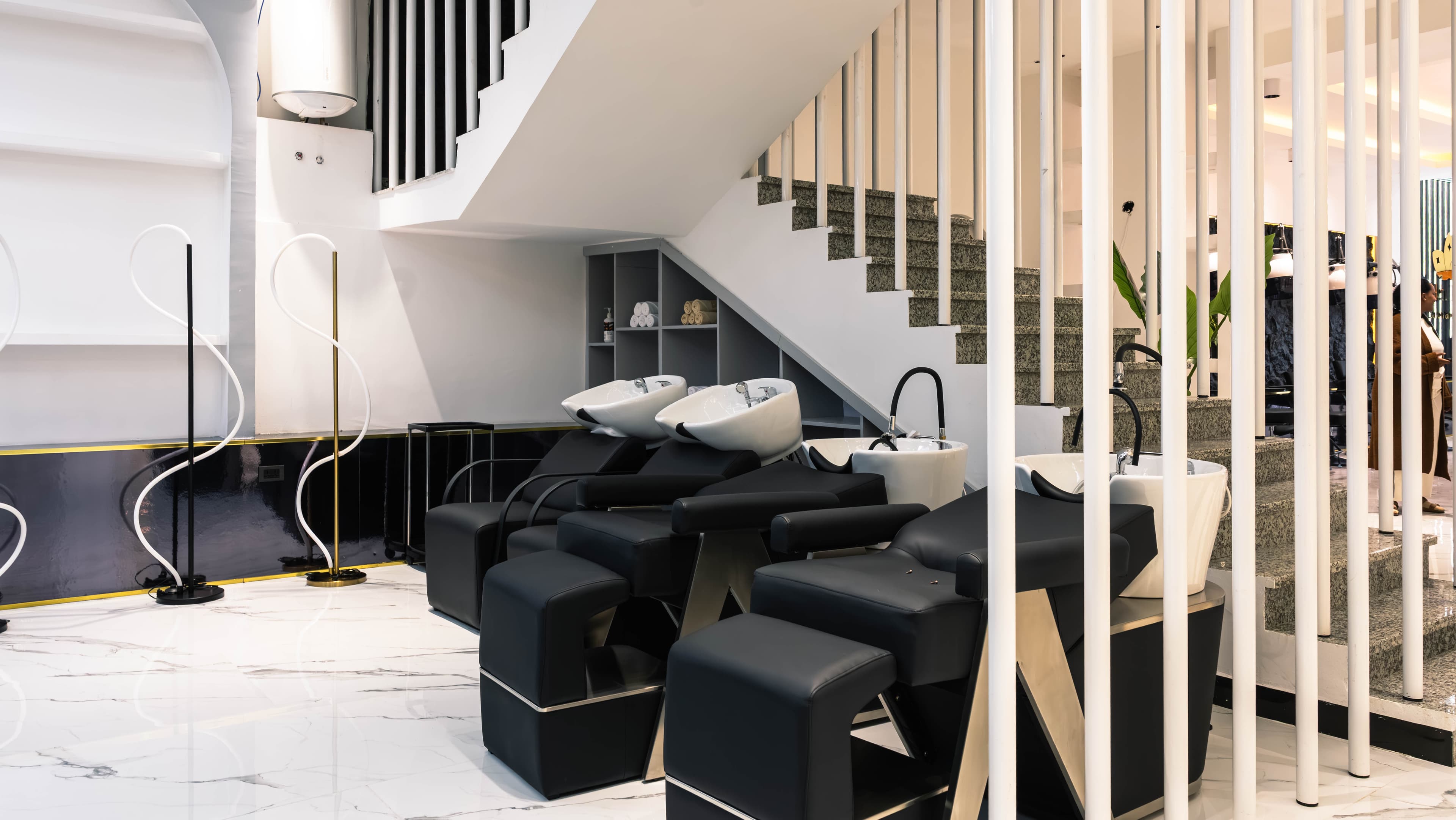 Hair wash stations beneath the staircase