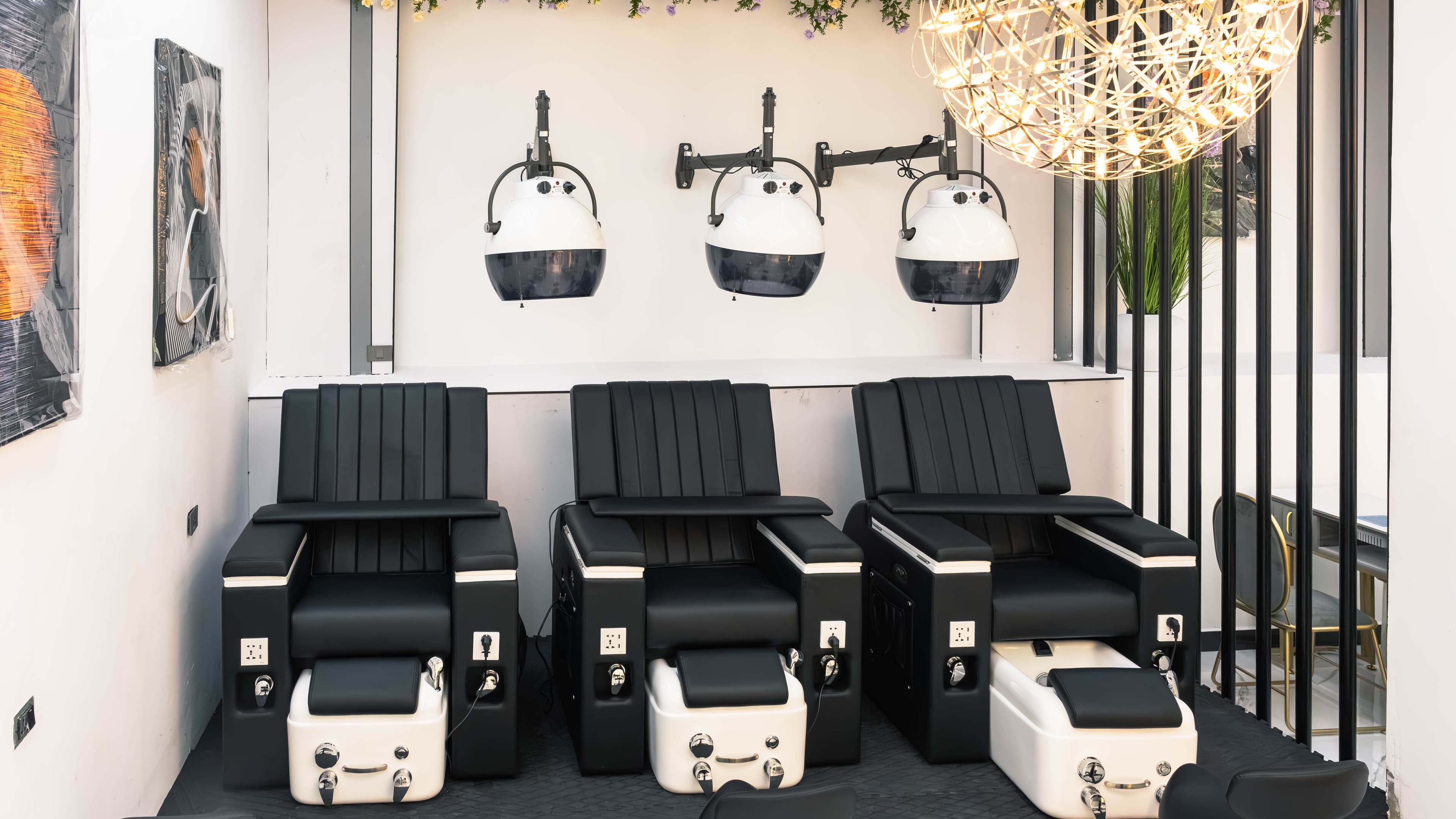 Pedicure chairs beneath hooded dryers