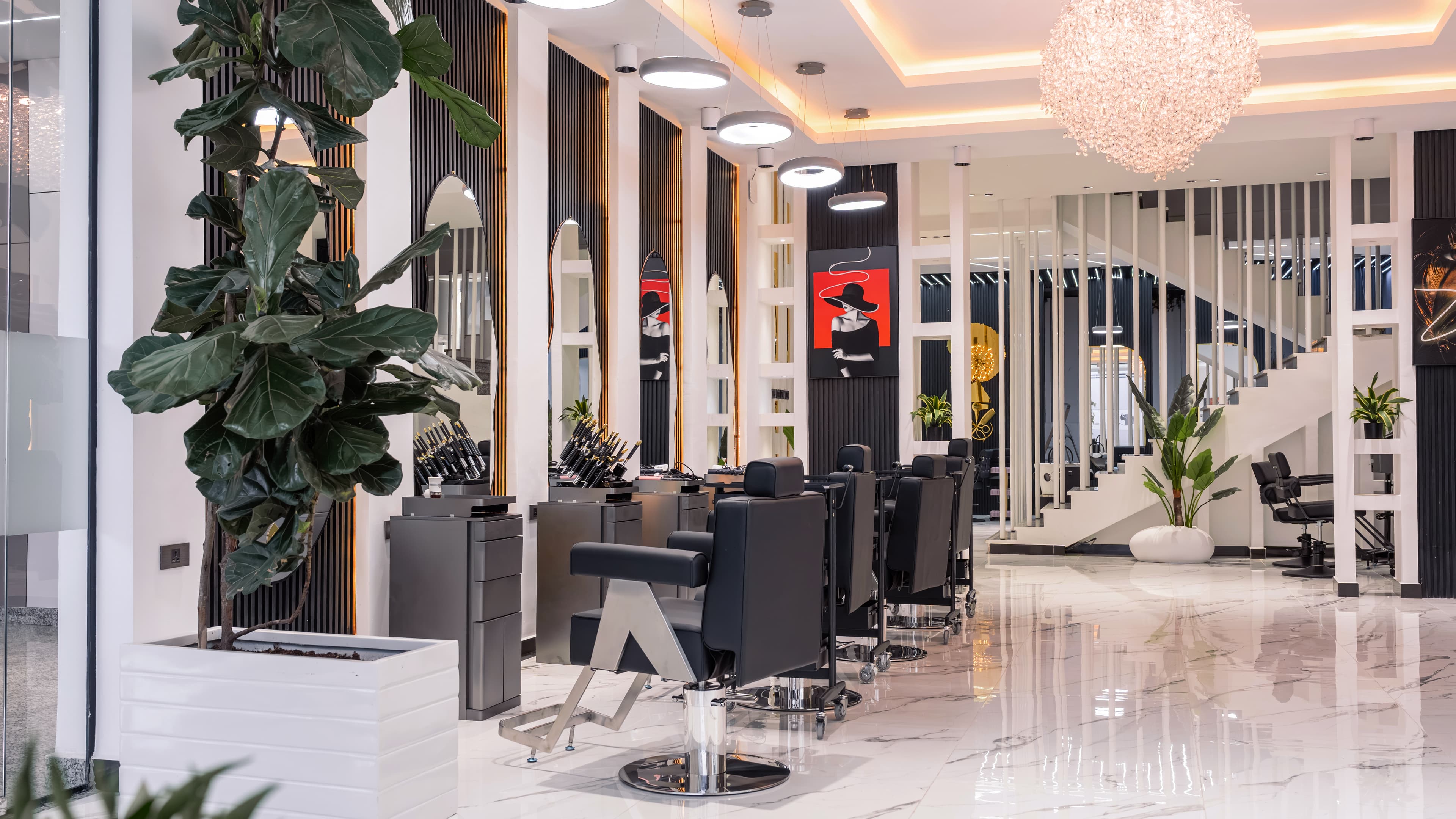 Hair wash stations in front of the Golden Bloom logo wall